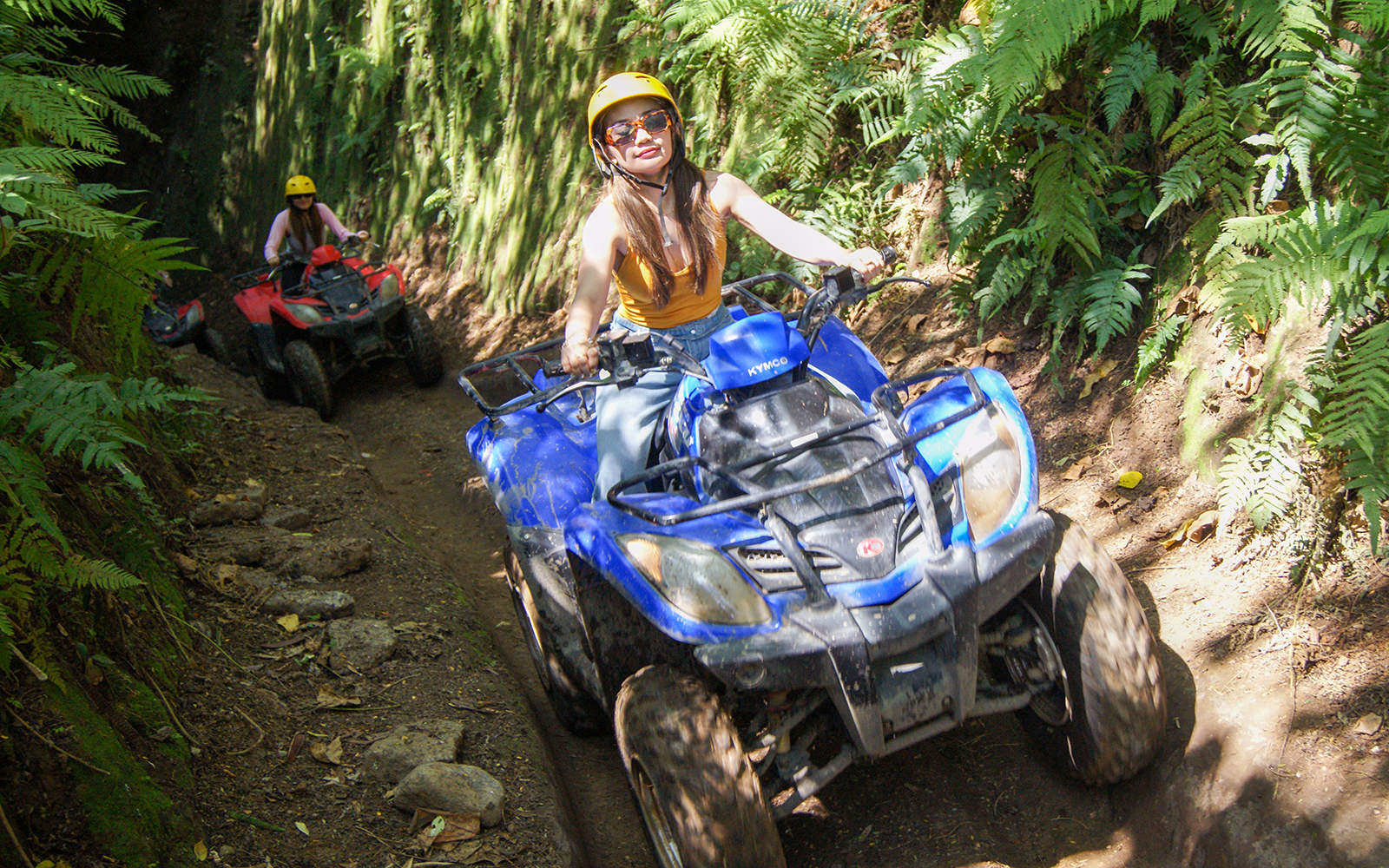 Bali ATV riders navigating a forest trail during a guided tour.