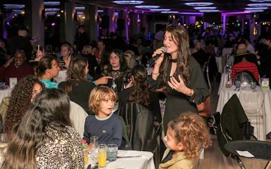 Singer performing for guests on Le Diamant Bleu Seine River dinner cruise.
