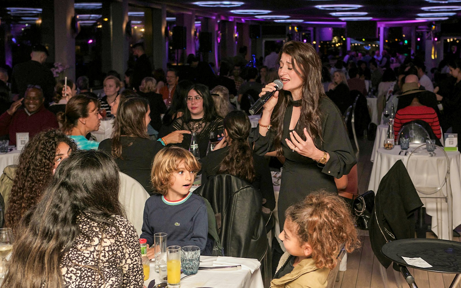 Singer performing on Le Diamant Bleu Seine River Dinner Cruise in Paris.