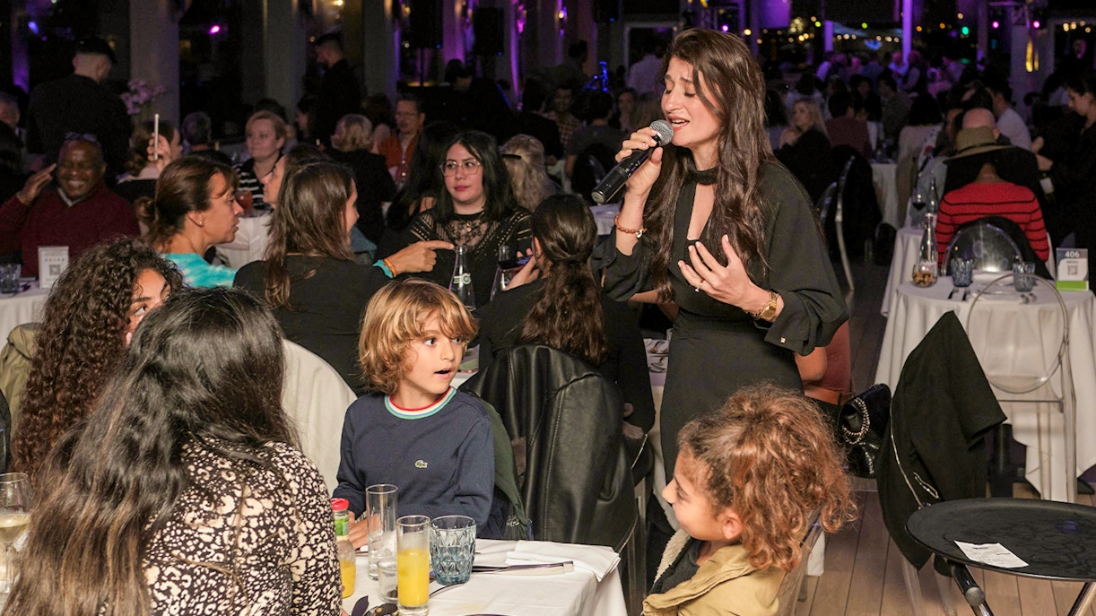 Singer performing on Le Diamant Bleu Seine River Dinner Cruise in Paris.