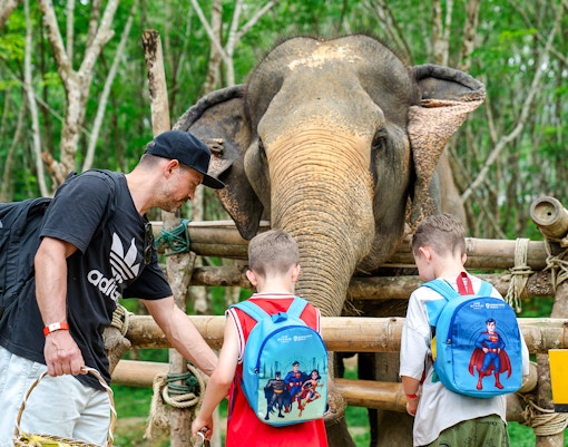 Family feeding elephant at Khaolak Ethical Elephant Sanctuary.