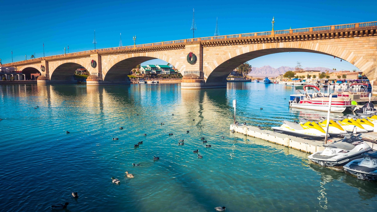 London Bridge over water with boats and ducks in Lake Havasu City, Arizona.