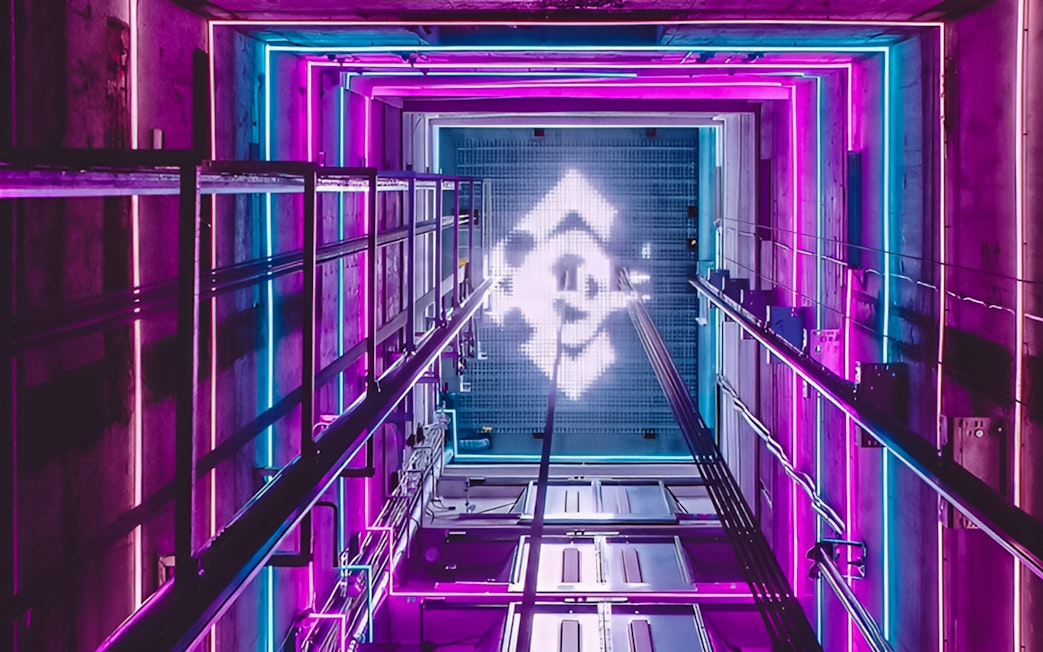 View from inside the A'DAM LOOKOUT elevator with vibrant neon lights.