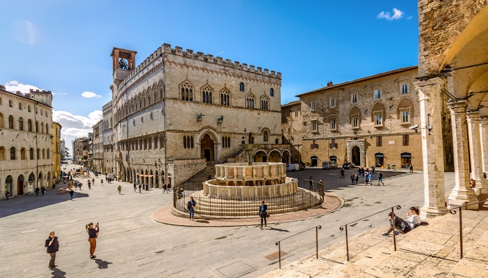 Perugia cityscape with historic buildings and lush greenery in Italy.