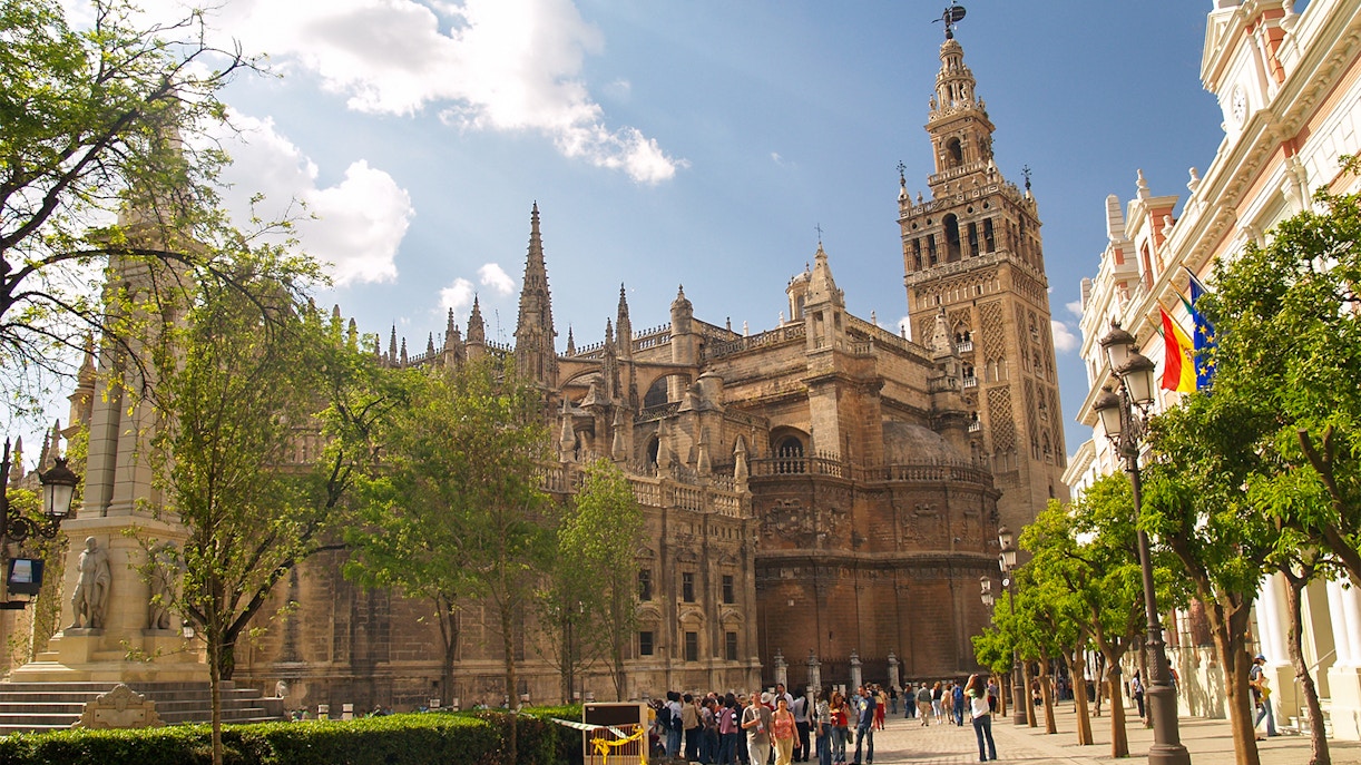 Seville Cathedral exterior with Gothic architecture and Giralda tower in Seville, Spain.
