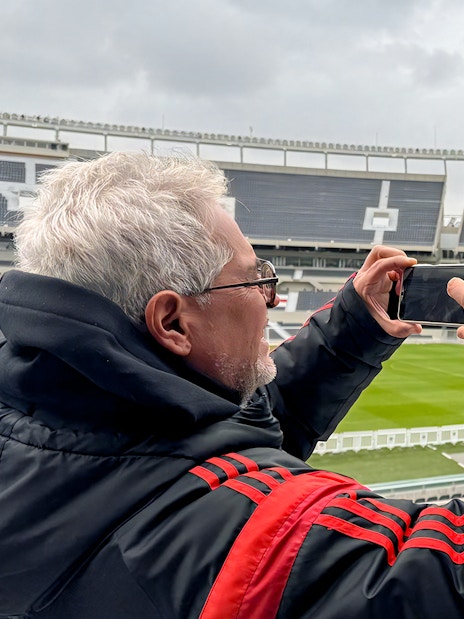 Tourist taking photos at La Bombonera stadium in Buenos Aires.