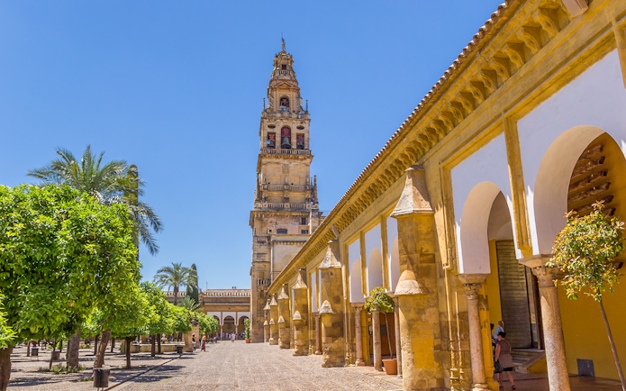Courtyard of the Mosque-Cathedral in Cordoba with bell tower, seen on a day trip from Seville.