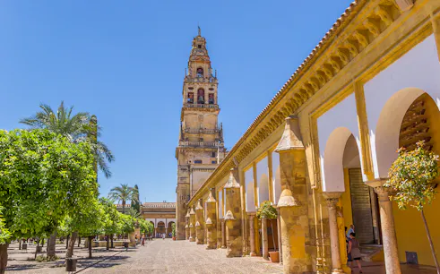 Courtyard of the Mosque-Cathedral in Cordoba with bell tower, seen on a day trip from Seville.
