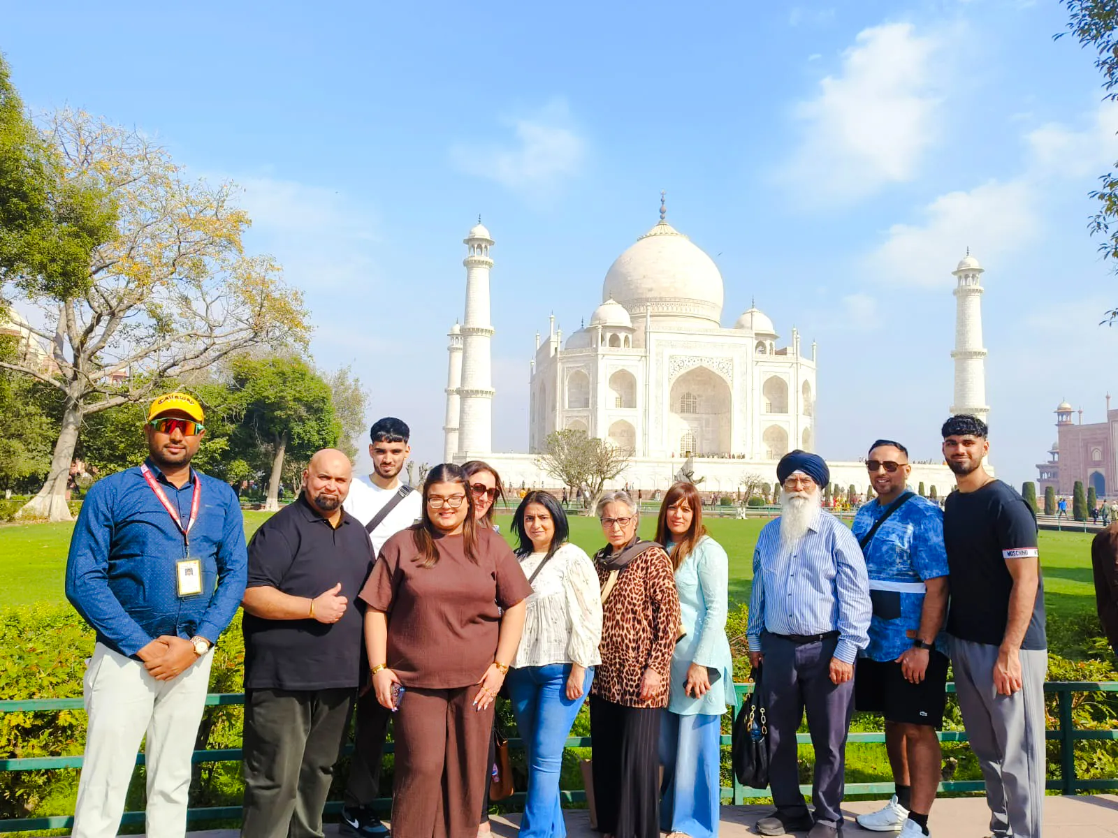 Group of tourists in front of the Taj Mahal during express entry tour in Agra.