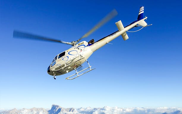 Helicopter flying over Bernese Seeland and Jura mountains.