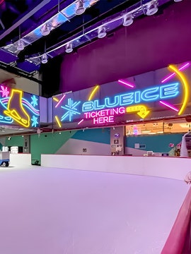 Neon signs at Blue Ice Skating Rink, 163 Retail Park, with ticketing area.