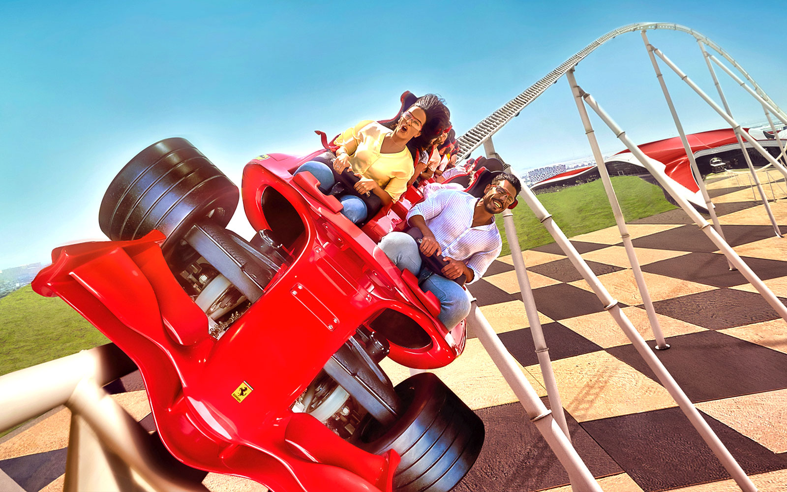 Roller coaster ride at Ferrari World Abu Dhabi with excited visitors.