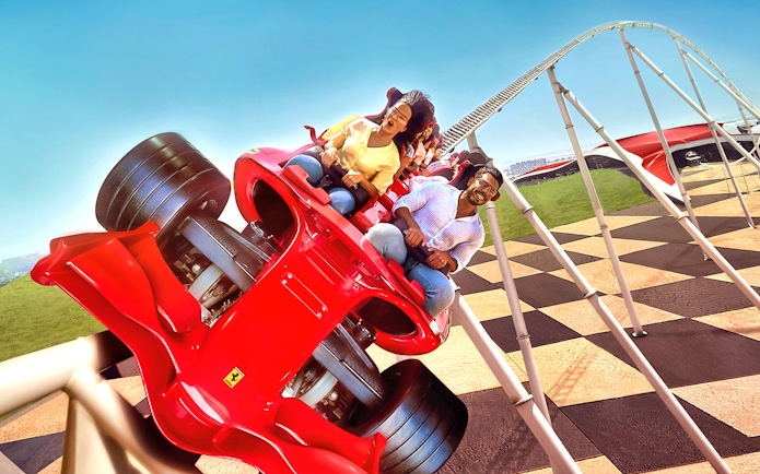 Roller coaster ride at Ferrari World Abu Dhabi with excited visitors.