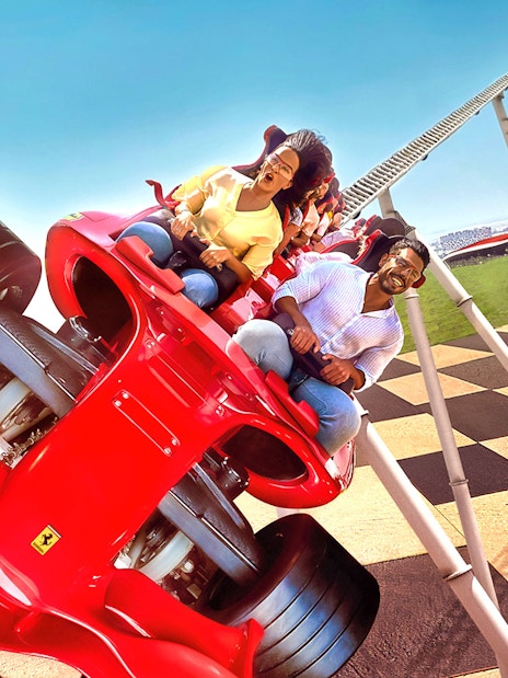 Roller coaster ride at Ferrari World Abu Dhabi with excited visitors.