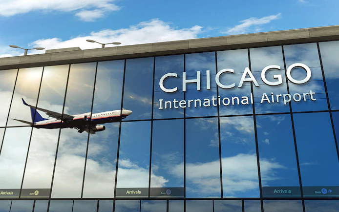 Airplane reflected on Chicago O'Hare Airport glass facade.