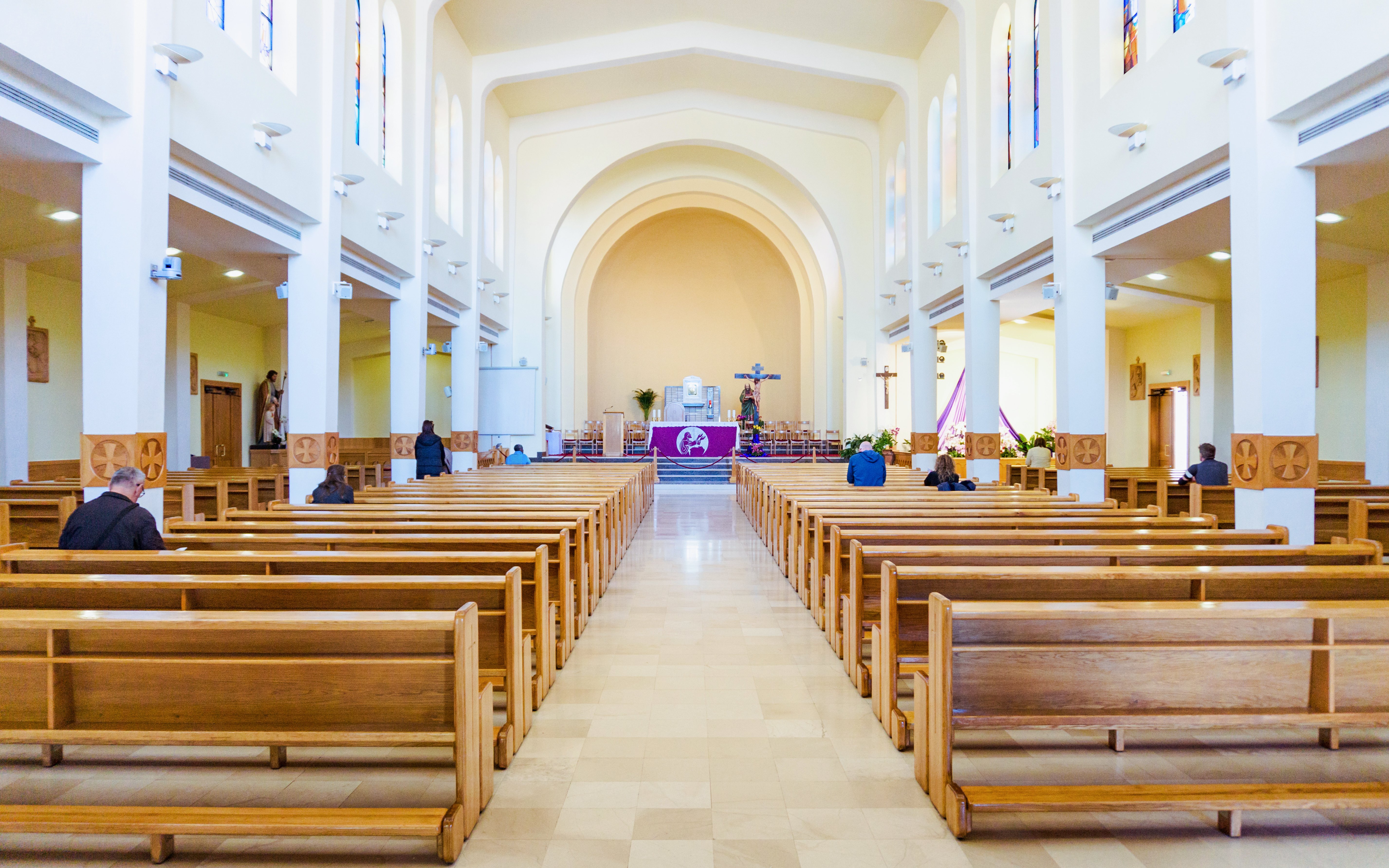 Interior view of St. James Church in Medjugorje with wooden pews and altar.