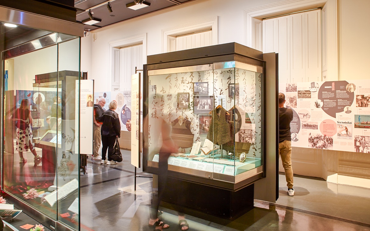 Visitors exploring exhibits at the Immigration Museum guided highlights tour.