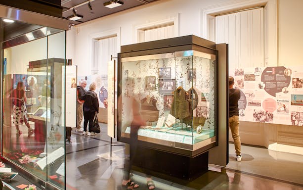 Visitors exploring exhibits at the Immigration Museum guided highlights tour.