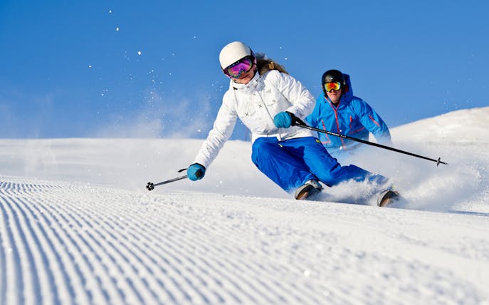 Skiers descending a snowy slope near Chochołów Thermal Baths, Krakow tour.
