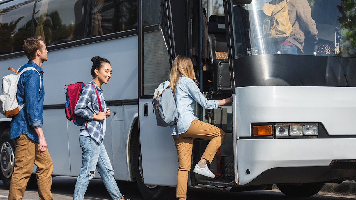 Travelers boarding a bus for Mount Batur sunrise trek with shared round-trip transfers.