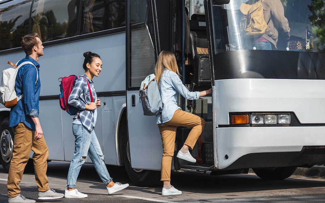 Tourists boarding bus for transfers to Astérix Parc.