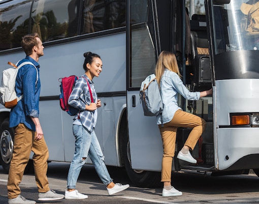 Tourists boarding bus for transfers to Astérix Parc.