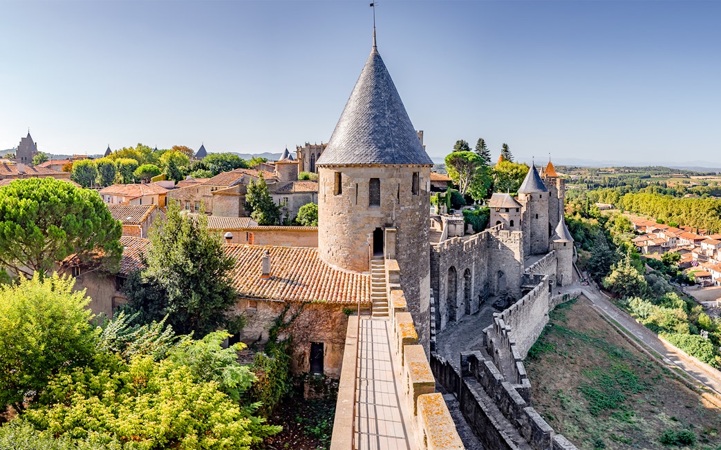 Carcassonne Castle ramparts with stone towers and surrounding landscape.