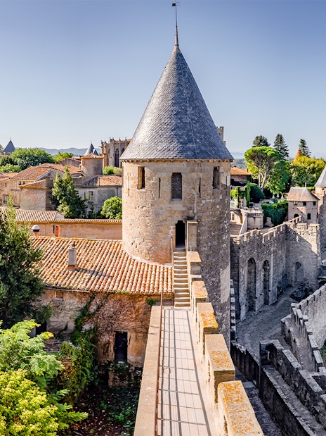 Carcassonne Castle ramparts with stone towers and surrounding landscape.