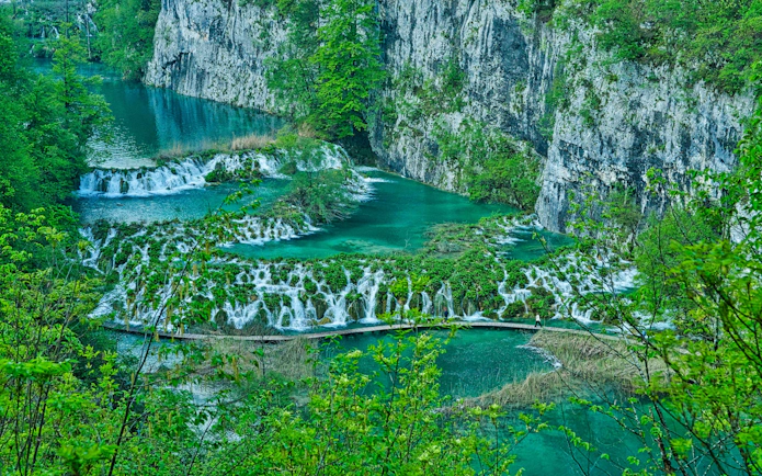 Aerial view of cascading waterfalls and turquoise lakes at Plitvice Lakes National Park, Croatia.