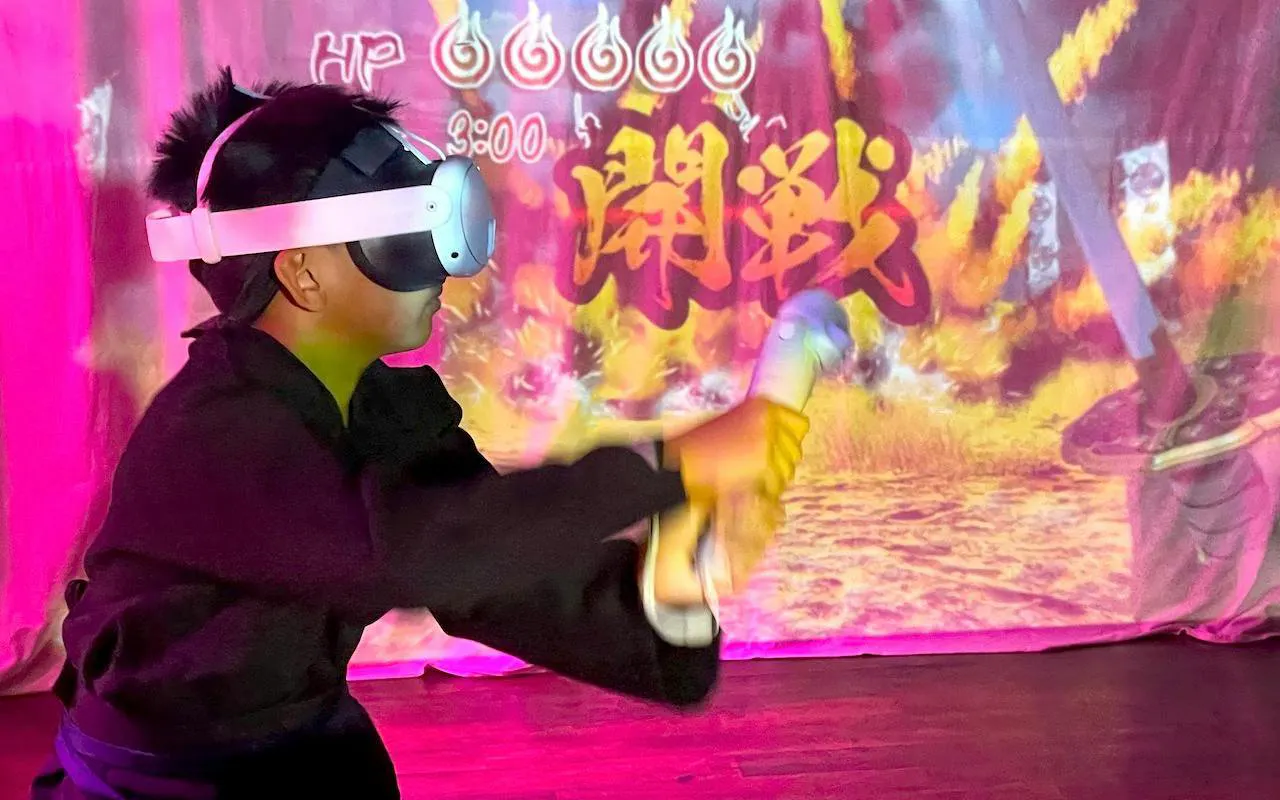 Child in VR headset practicing ninja skills at Osaka Ninja Workshop.