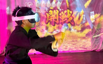 Child in VR headset practicing ninja skills at Osaka Ninja Workshop.