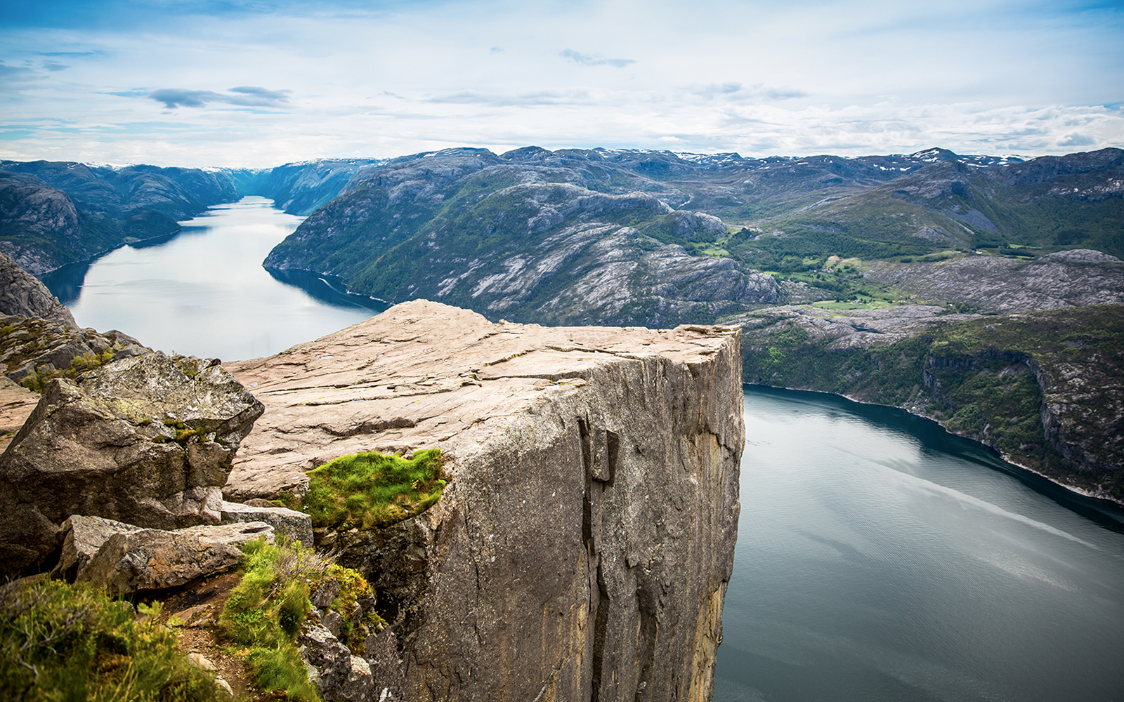 Hikers on Pulpit Rock overlooking Lysefjord in Stavanger, Norway.