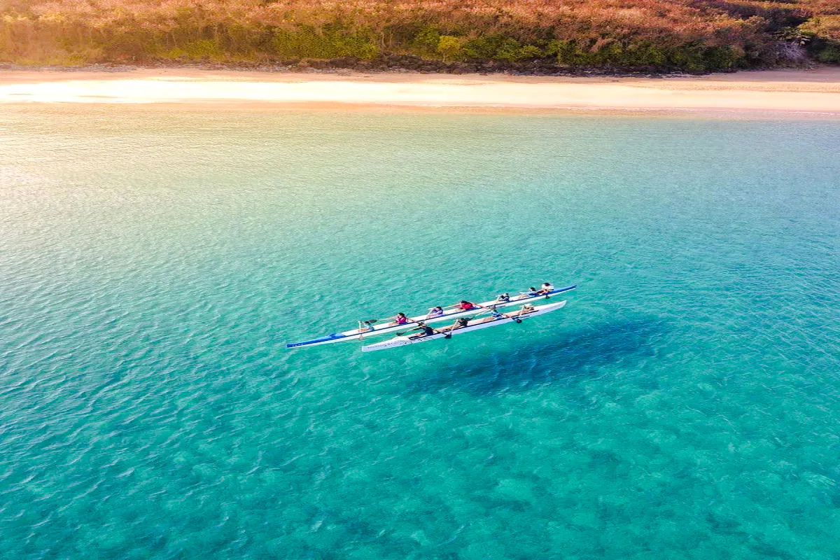 Outrigger canoe on clear waters near a sandy beach, Noronha, Sao Paulo.