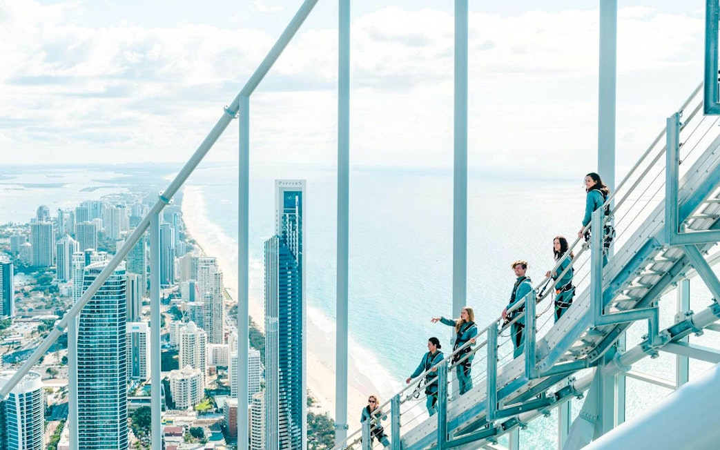Guests climbing Skypoint day climb with Gold Coast skyline and ocean view.