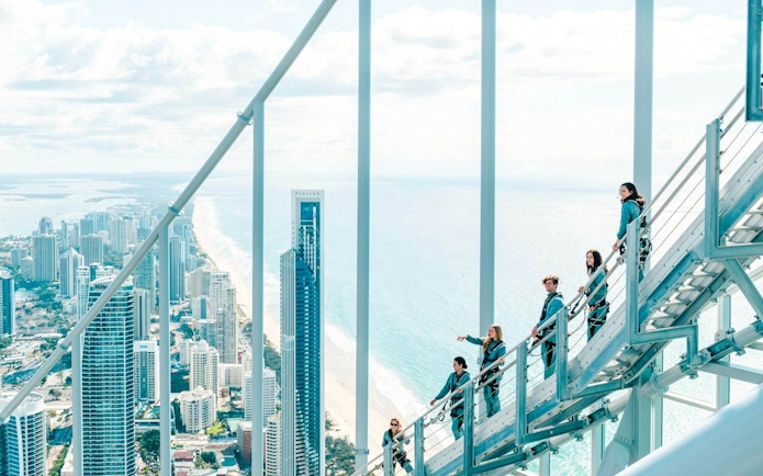Guests climbing Skypoint day climb with Gold Coast skyline and ocean view.
