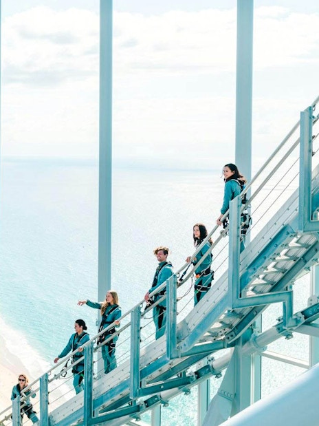 Guests climbing Skypoint day climb with Gold Coast skyline and ocean view.