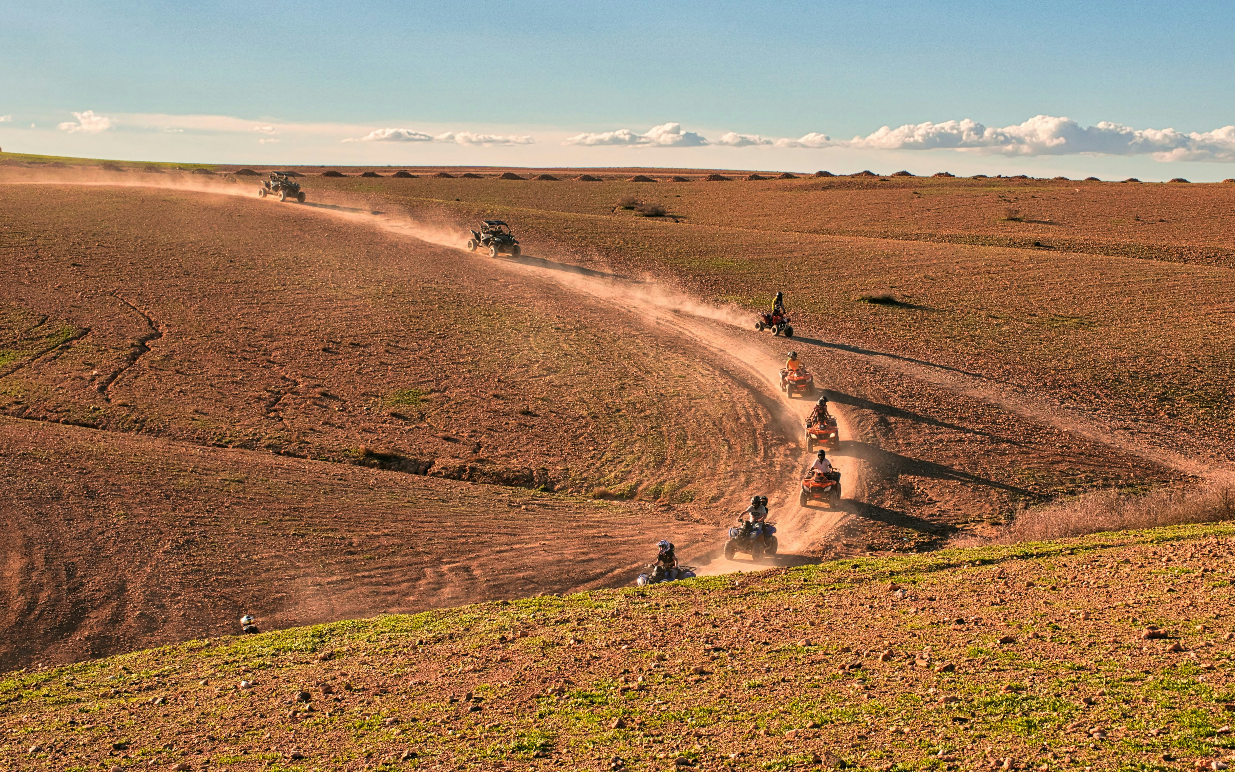 Quad bikes on a dusty trail in Agafay Desert, Morocco.