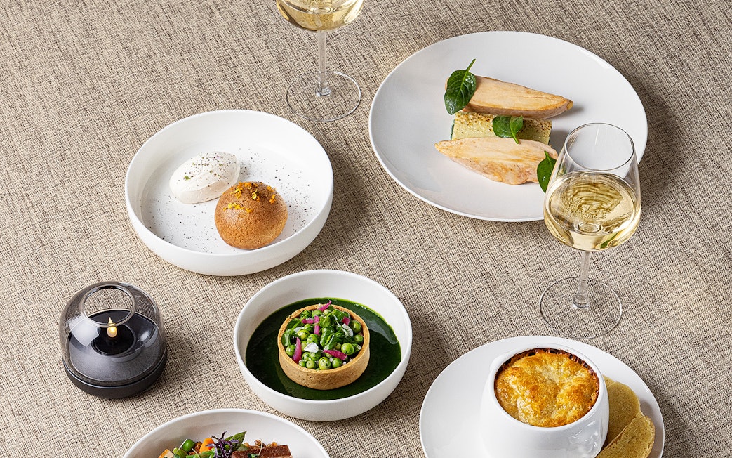 Lunch dishes at Madame Brasserie, Eiffel Tower, featuring gourmet plates and wine.