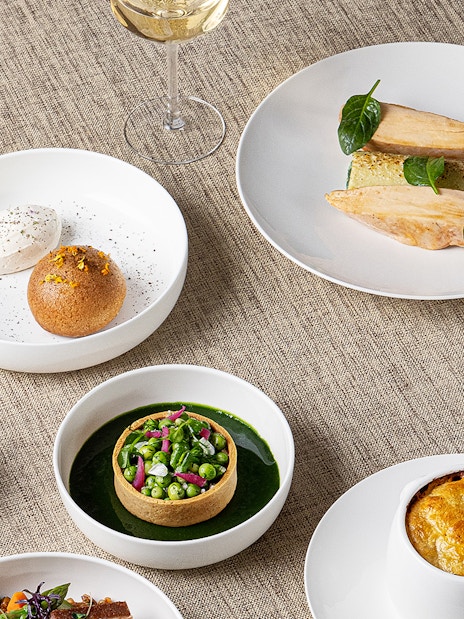 Lunch dishes at Madame Brasserie, Eiffel Tower, featuring gourmet plates and wine.
