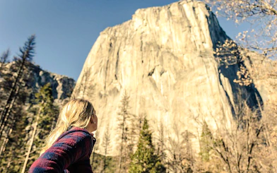 Visitor admiring El Capitan in Yosemite National Park, California.