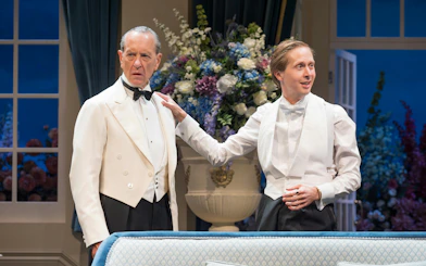 Actors in formal attire during a scene from "HAY FEVER" at Westend theater.