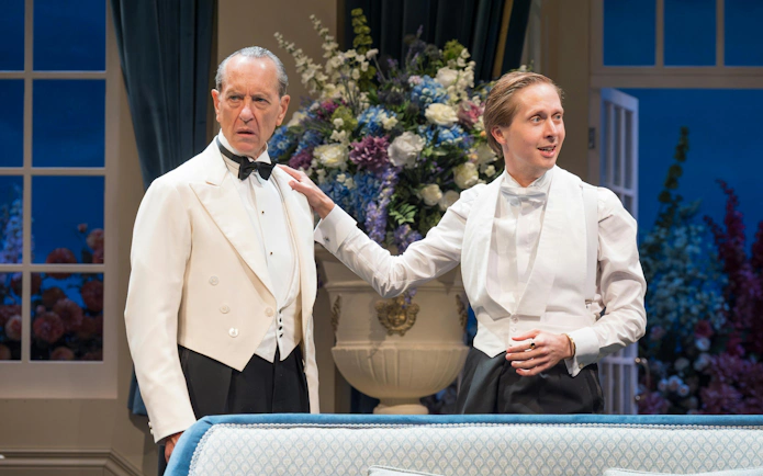 Actors in formal attire during a scene from "HAY FEVER" at Westend theater.