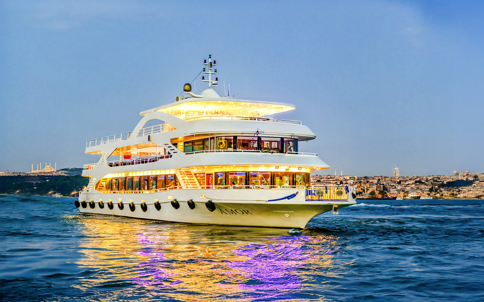 Bosphorus dinner cruise ship with guests dining, Bosporus Strait, evening view.