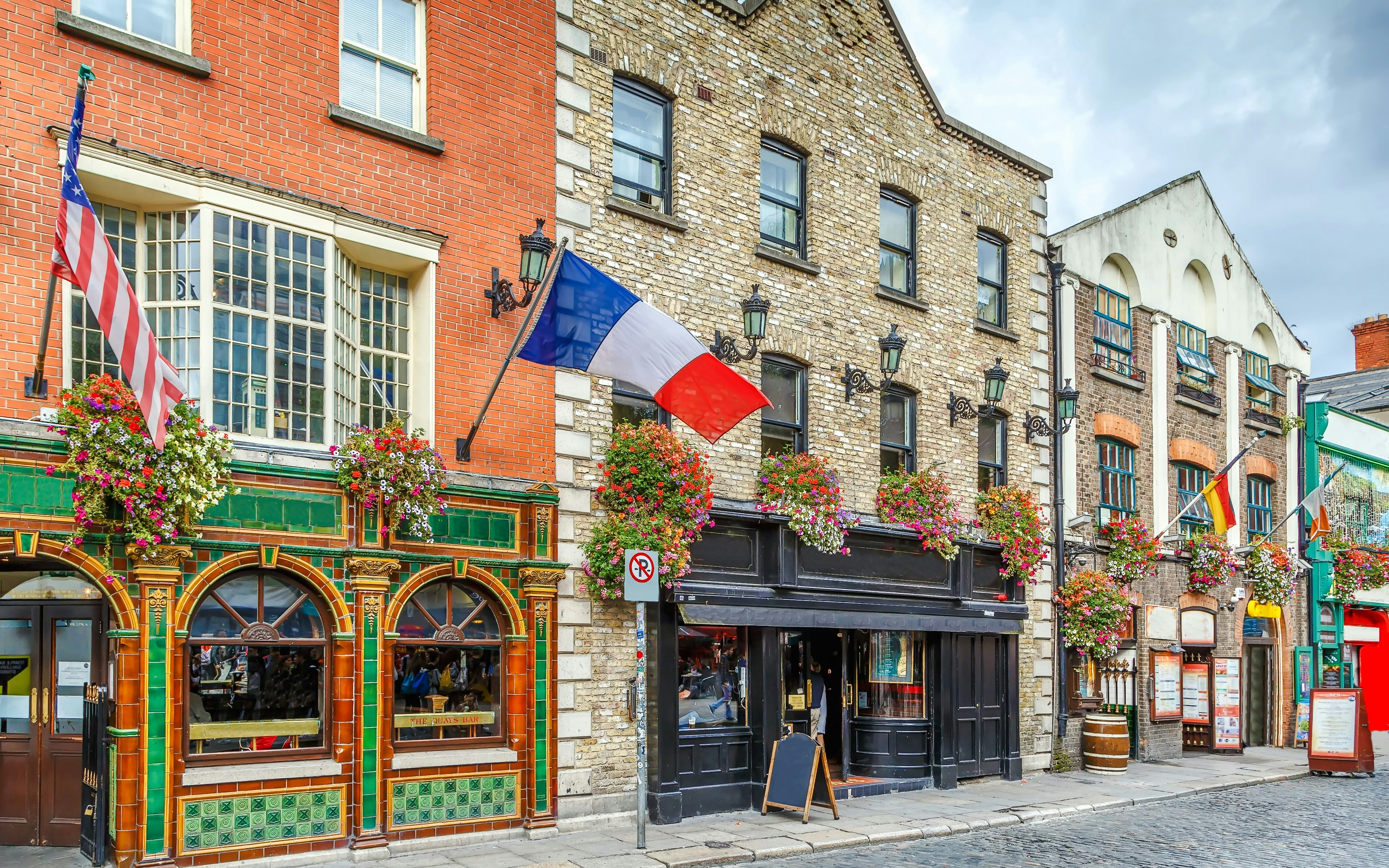 Temple Bar street with colorful pubs and flags, Dublin, Ireland.
