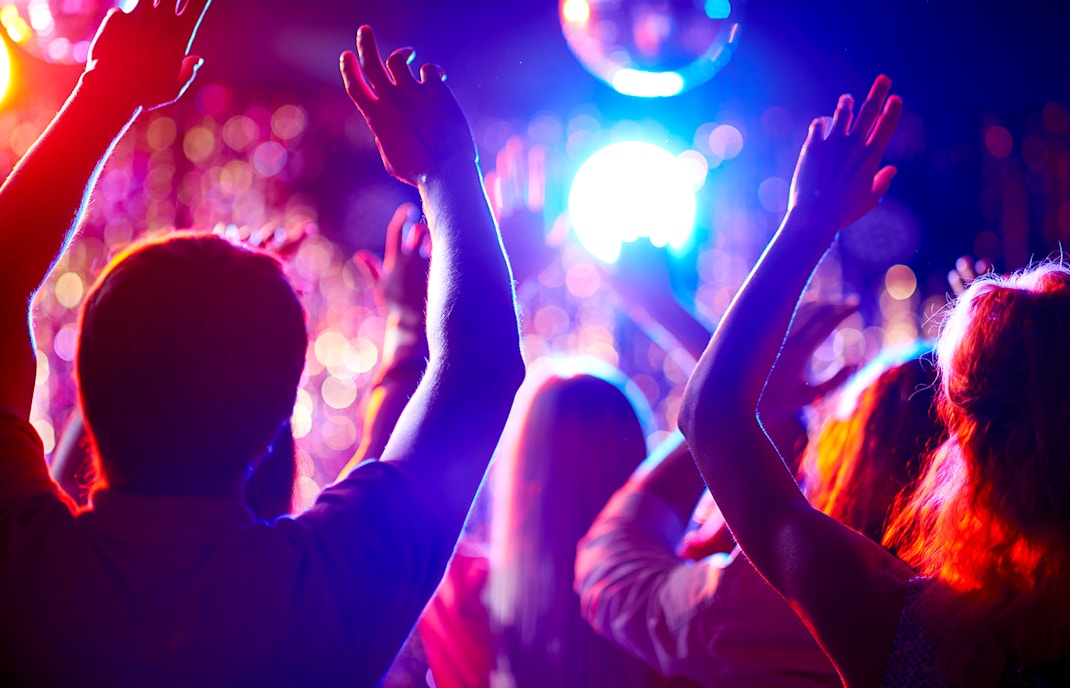 Group of happy multiracial friends dancing at sunrise beach party in summer vacation