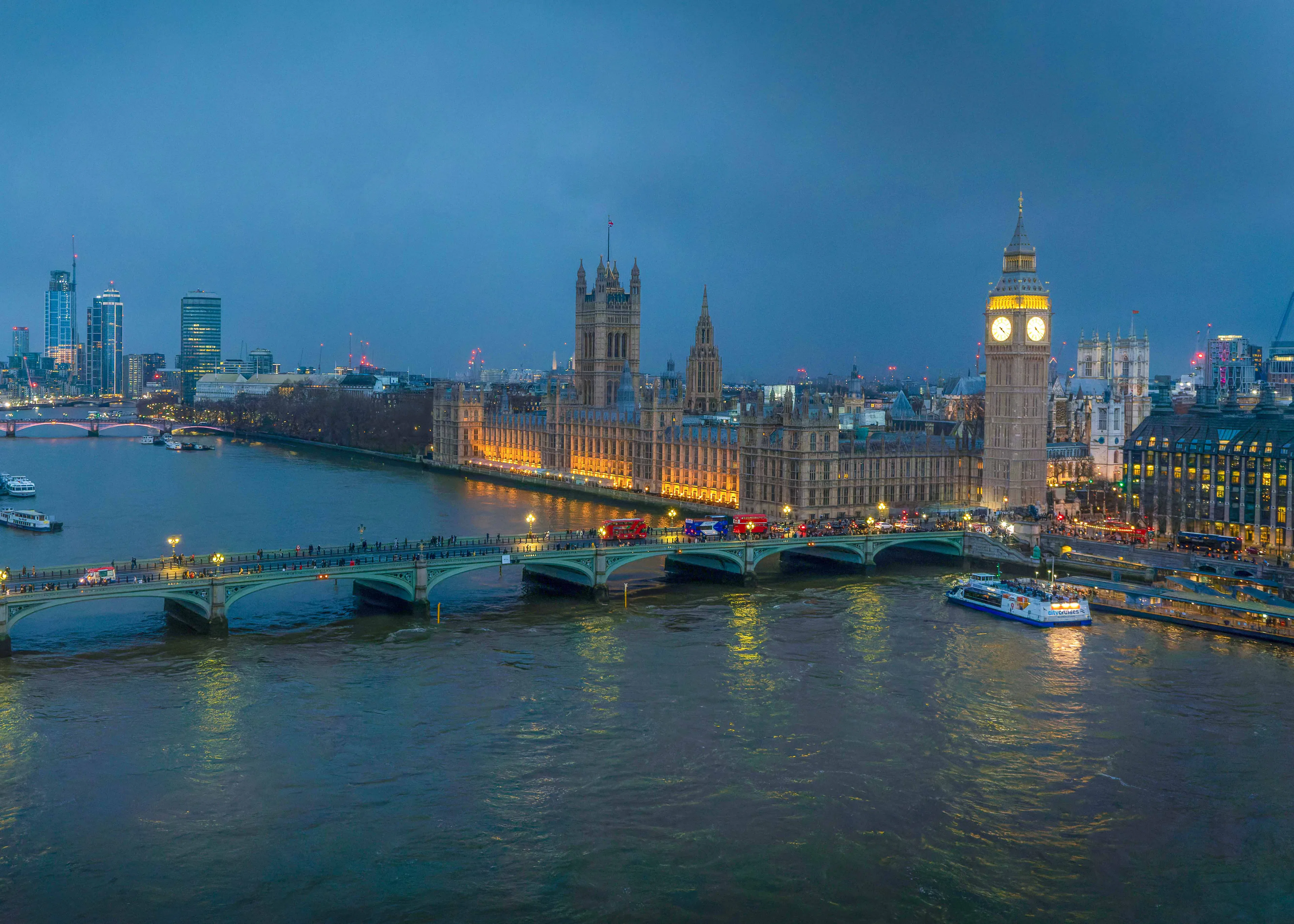 Westminster Bridge and Big Ben illuminated at night, view from the London Eye.