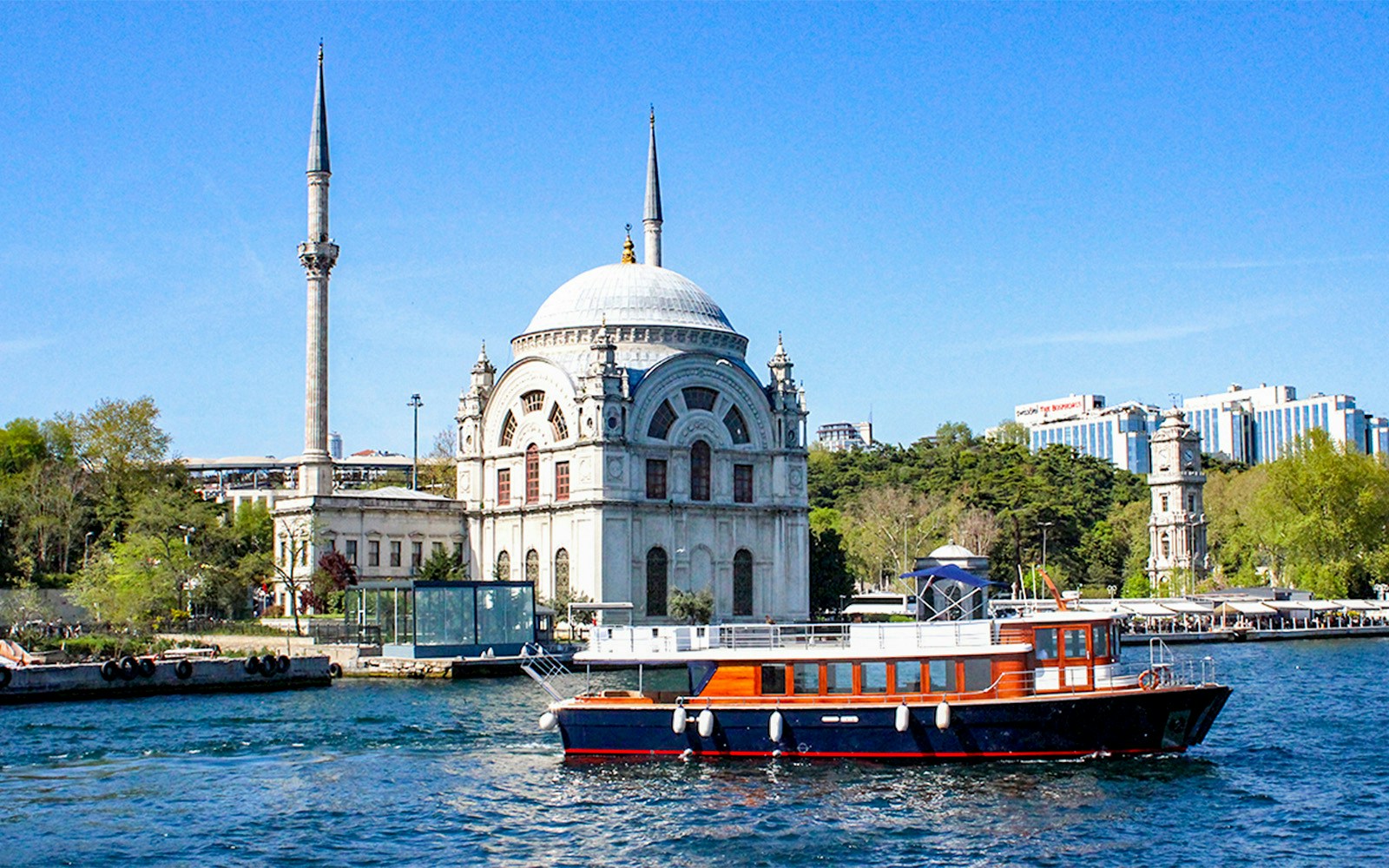 Bosphorus cruise boat passing by Istanbul's Ortaköy Mosque.