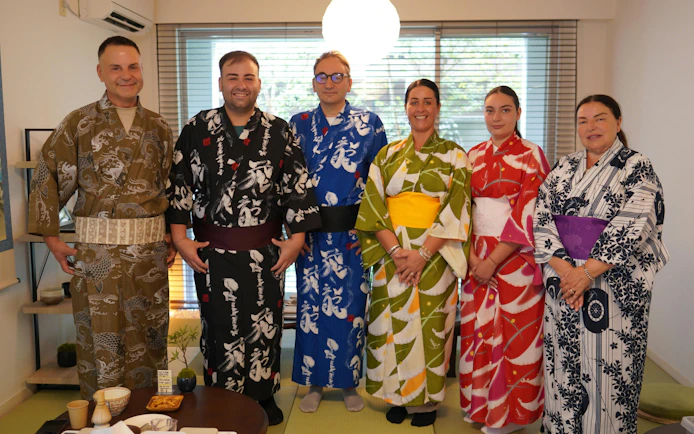 Group wearing kimonos during a tea ceremony experience in Tokyo.
