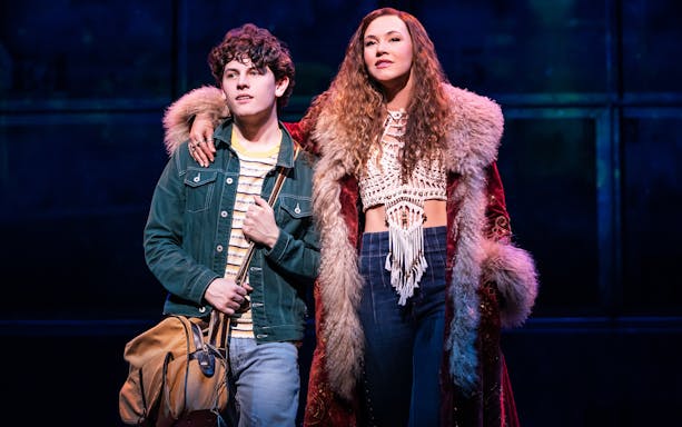 Two actors on stage in a scene from the musical "Almost Famous.