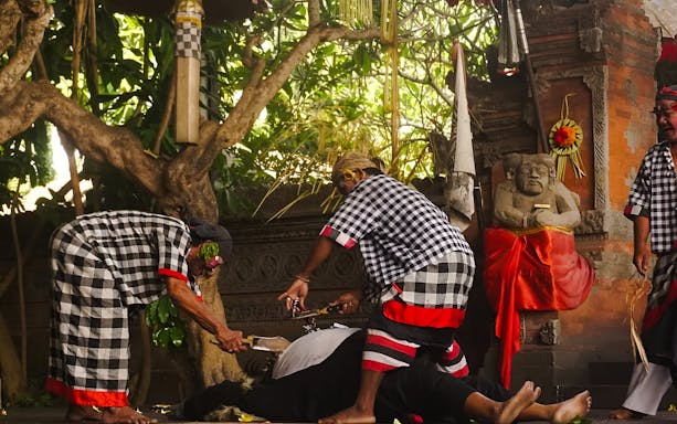 Uluwatu Kecak & Fire Dance performers in traditional attire during a dramatic scene.